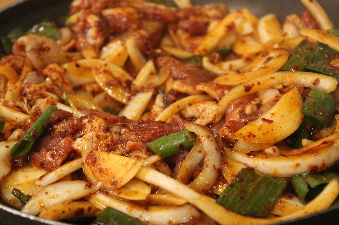 Wok with sizzling beef and caramelized onions stir-frying for a quick dinner