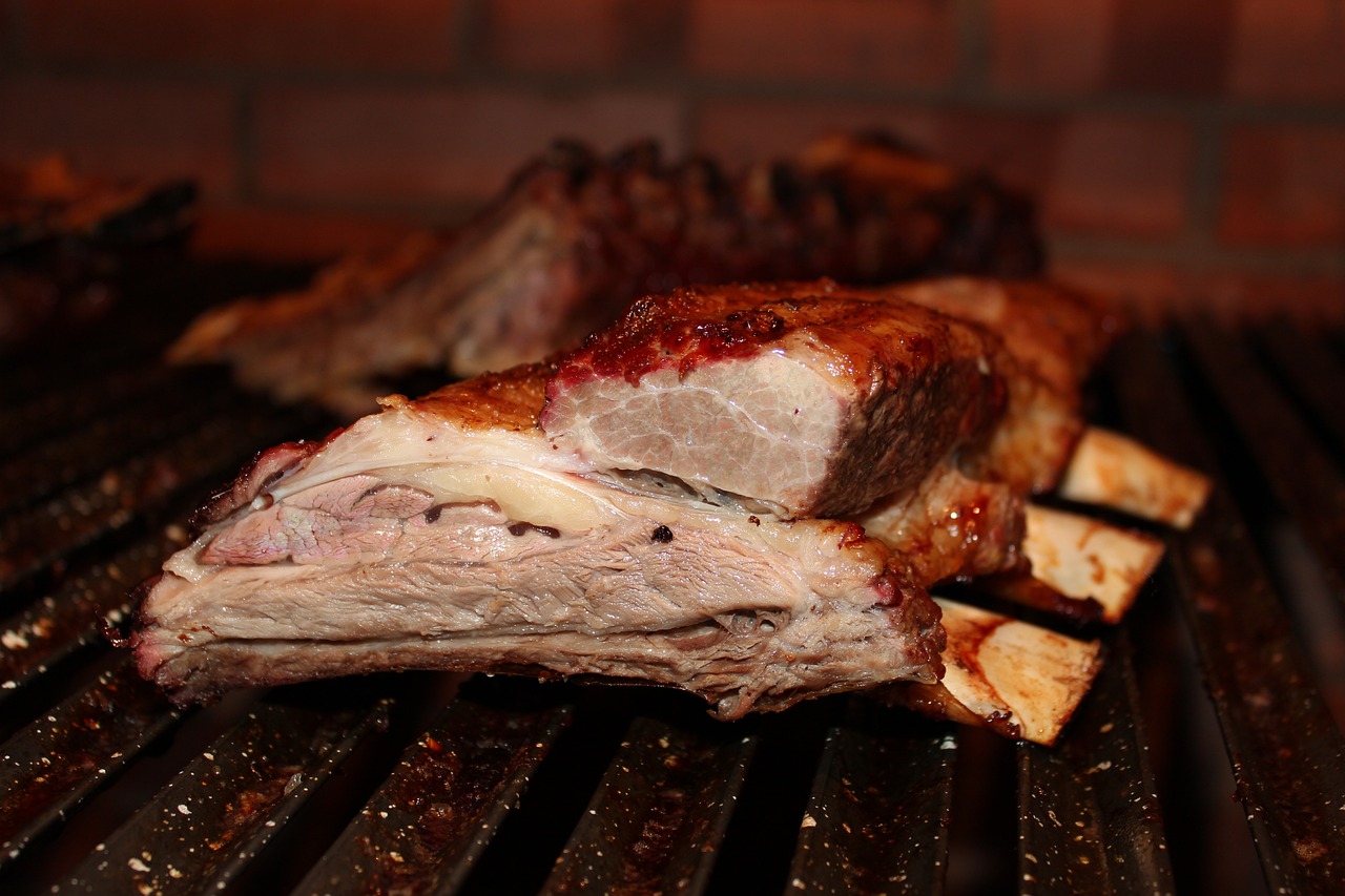 Image of Herb-Crusted Lamb Chops on Grill: "Herb-crusted lamb chops sizzling on a Traeger pellet grill, showcasing a golden-brown crust and juicy interior."