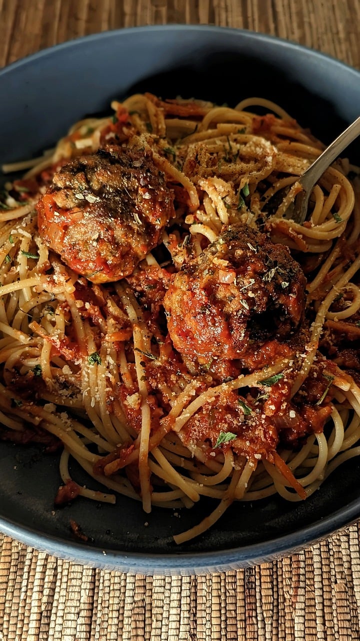 Here are some caption ideas for each step of the homemade spaghetti recipe: Main Dish: "This irresistible homemade spaghetti is the ultimate comfort food, made with a savory tomato sauce and fresh herbs." Ingredients: "Gather these simple, fresh ingredients to make the best spaghetti sauce from scratch." Cooking Process: "Simmering the sauce to perfection! Let those flavors meld for a delicious, rich taste." Serving: "Serve up a hearty bowl of spaghetti with garlic bread on the side—perfect for sopping up every last drop." Close-up of Finished Dish: "Every bite of this homemade
