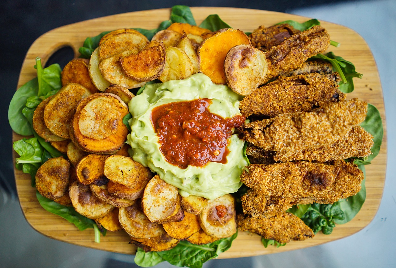 Assorted crispy baked vegetables on a baking sheet – A colorful array of roasted vegetables, including carrots, zucchini, and bell peppers, spread in a single layer on a parchment-lined baking sheet.