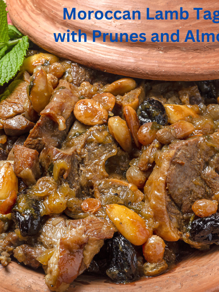 A traditional Moroccan lamb tagine with prunes and almonds, garnished with sesame seeds and served in a clay tagine dish.
