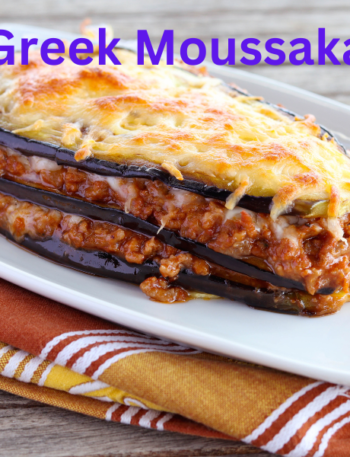 A delicious slice of Greek Moussaka with golden BΓ©chamel topping, layered with roasted eggplant, potatoes, and savory meat sauce, served on a white plate