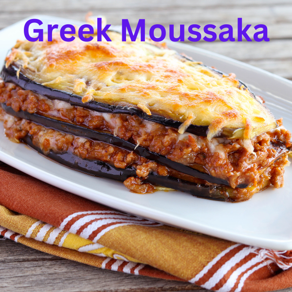 A delicious slice of Greek Moussaka with golden Béchamel topping, layered with roasted eggplant, potatoes, and savory meat sauce, served on a white plate