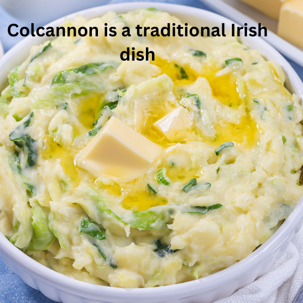A bowl of creamy Colcannon mashed potatoes with cabbage and green onions, topped with melted butter